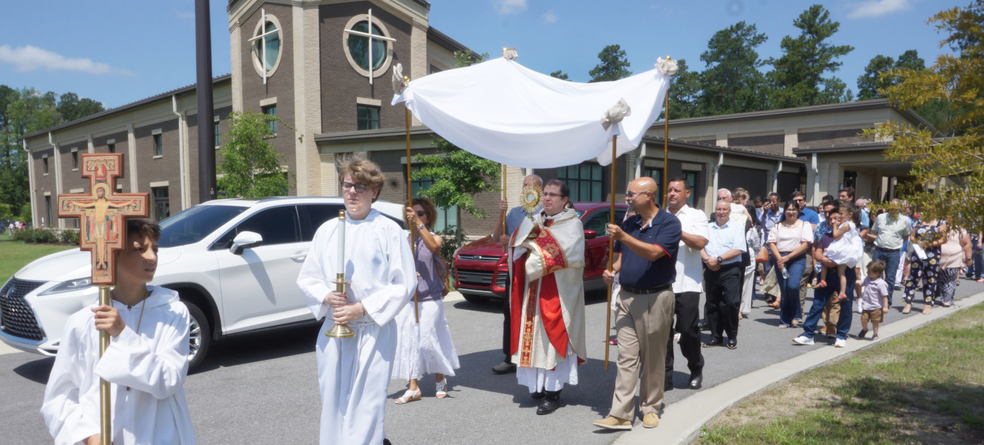 Fr. Pablo leading the congregation in a parade outside of the church